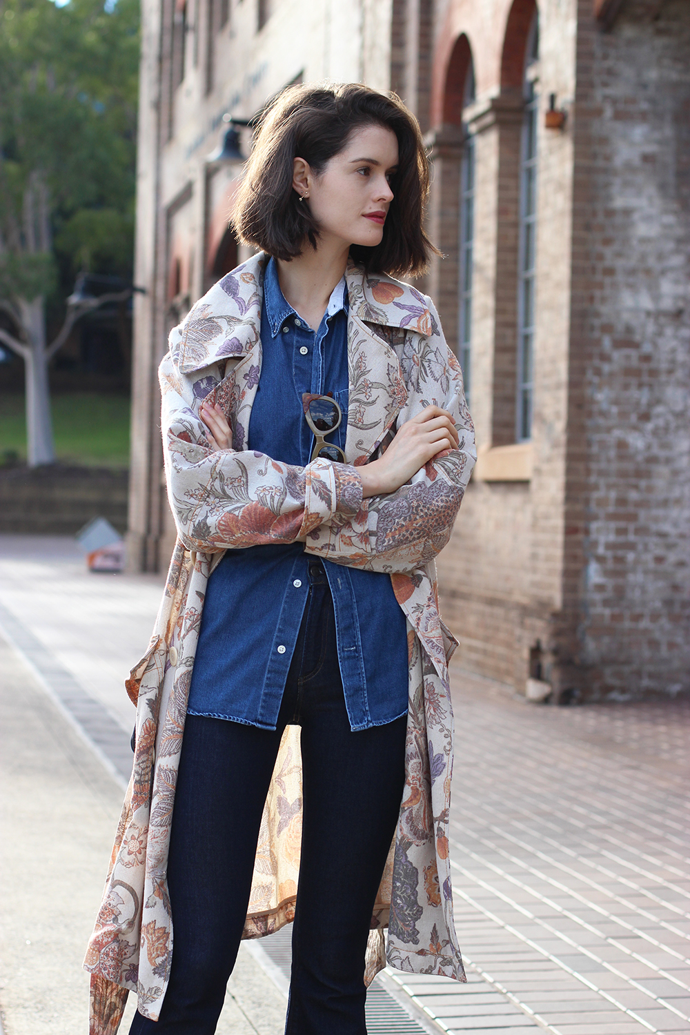 Australian Fashion Blog | Chloe Hill wearing Karen walker trench coat, acne denim shirt, pared sunglasses, Alila floral print bag and citizens of humanity sculpt flares at carriage works