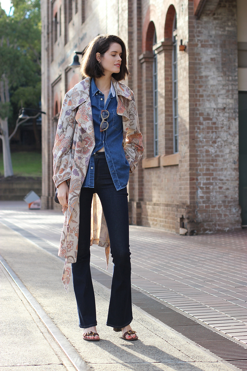 Australian Fashion Blog | Chloe Hill wearing Karen walker trench coat, acne denim shirt, pared sunglasses, Alila floral print bag and citizens of humanity sculpt flares at carriage works